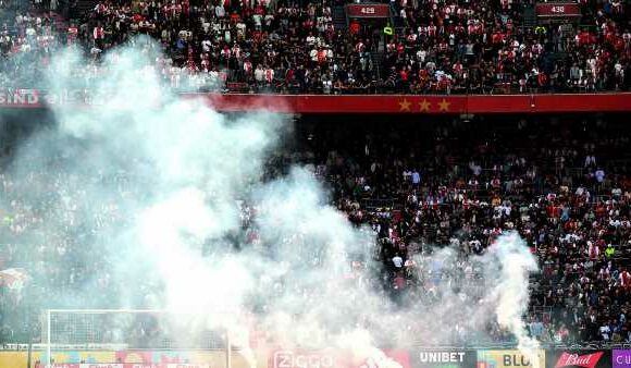 Ajax match SUSPENDED after fans throw flares on pitch at 3-0 down