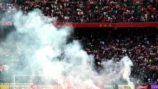 Ajax match SUSPENDED after fans throw flares on pitch at 3-0 down